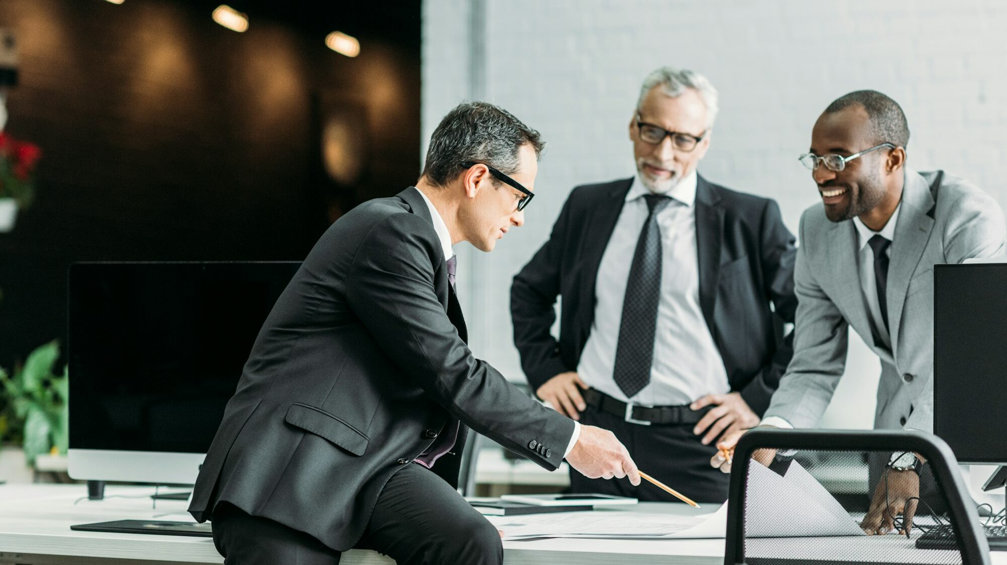 multiethnic businessmen discussing new business strategy on meeting in office