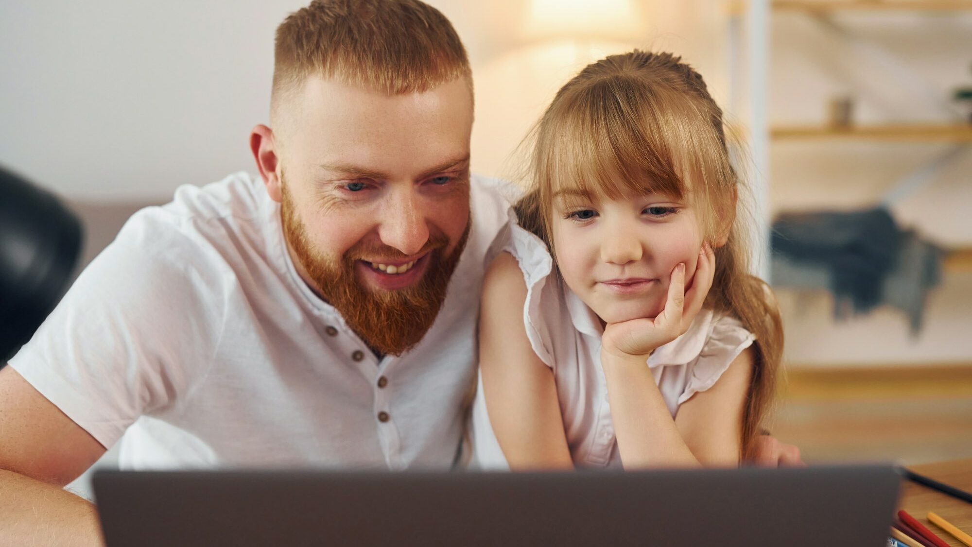 Online learning. Father with his little daughter is at home together